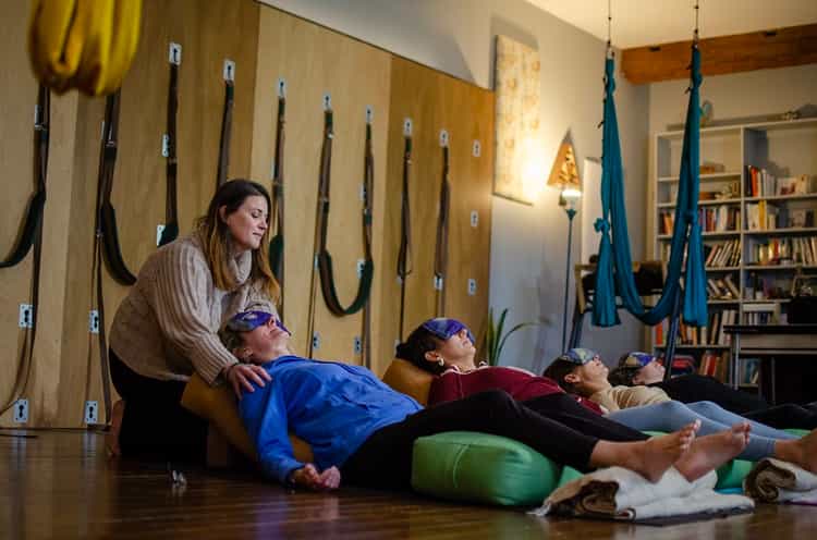 teacher and students meditating in a mindfulness meditation program class